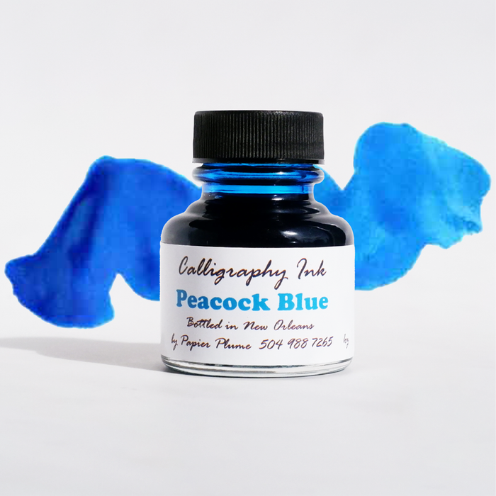 Peacock Blue calligraphy ink in a glass bottle from Papier Plume, showcasing vibrant blue ink suitable for elegant writing and art.