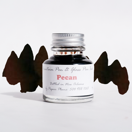 Papier Plume fountain pen ink bottle labeled Pecan, featuring rich brown ink for writing and calligraphy.