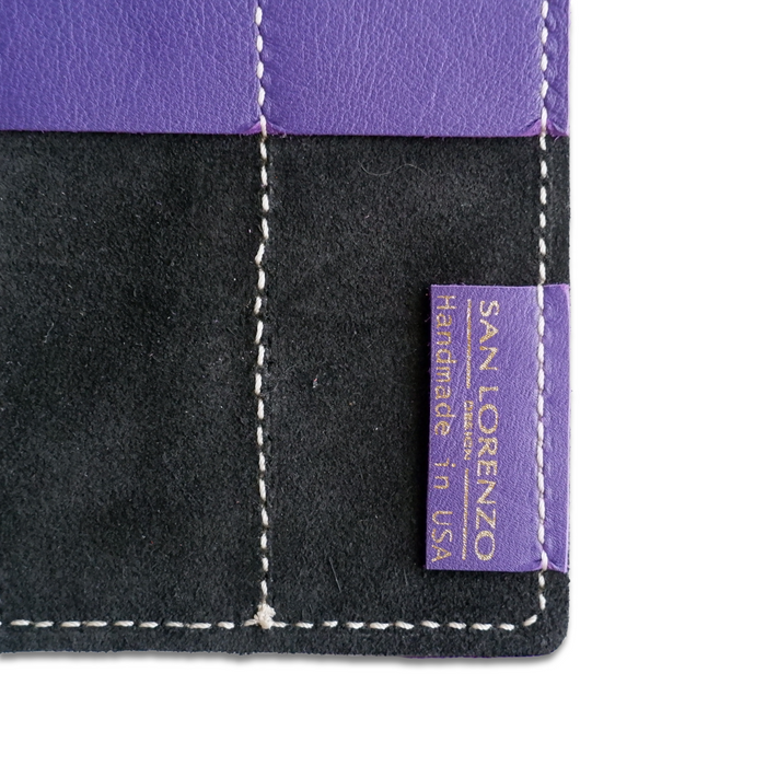 San Lorenzo leather pen roll in royal purple with multiple pen slots, compact and stylish for organizing writing instruments.