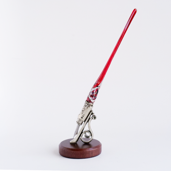 Bortoletti calligraphy pen rest in elegant design, holding a calligraphy pen on a wooden surface.