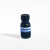 Papier Plume Pavo Real fountain pen ink in a glass bottle with vibrant blue and green ink inside.