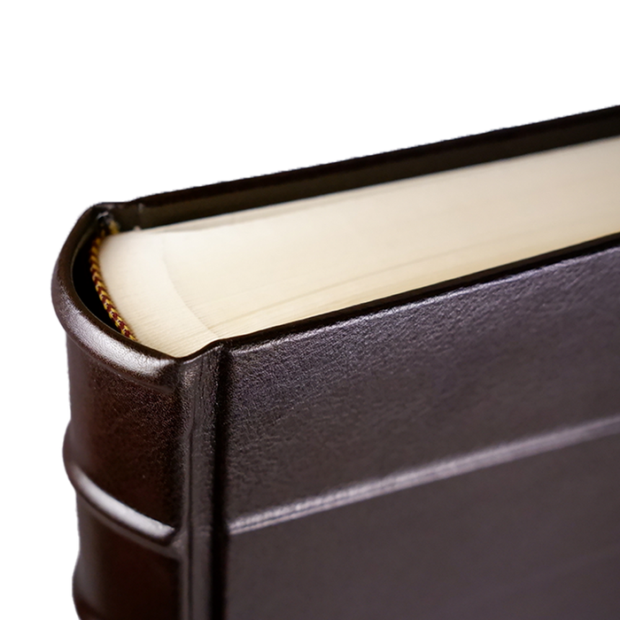Dark leather photo album by Il Cartiglio with stitched binding and elegant pages, suitable for preserving cherished photographs.