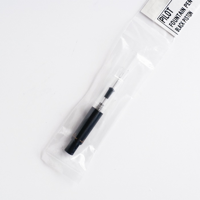 Black Pilot piston converter for fountain pens, showcasing a sleek design and high-quality construction.