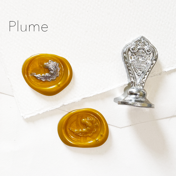 Le Potier D'etain wax seal featuring a detailed plume design on a white background.