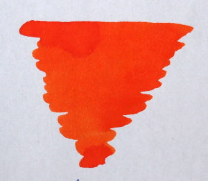 Diamine Pumpkin fountain pen ink in a glass bottle, featuring vibrant orange ink with a smooth, flowing design.