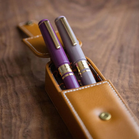 Esterbrook Model J fountain pen from the Purple Collection with purple resin body and gold accents, displayed on a white background.