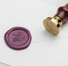 Papier Plume Script Monogram wax seal featuring elegant Q-script design on a white background.