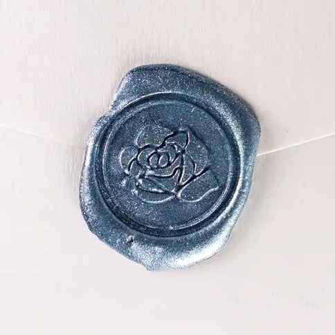 Brass wax seal with rose symbol by Papier Plume, featuring intricate floral design for sealing and decorative purposes.