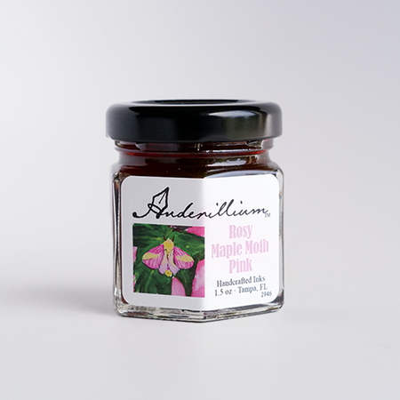 Anderillium Rosy Maple Moth Pink fountain pen ink in a glass bottle with vibrant pink ink visible inside.