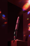 Nahvalur Eclipse fountain pen with emerald and ruby accents, featuring a sleek design and fine nib for elegant writing.
