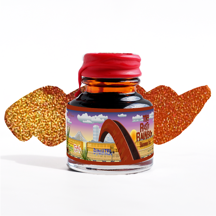 Papier Plume Rusty Rainbow shimmer fountain pen ink in a glass bottle with vibrant, metallic orange and gold ink visible inside.