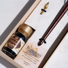 Bortoletti wood and bronze dip calligraphy pen set with nibs and ink bottle on a wooden surface.