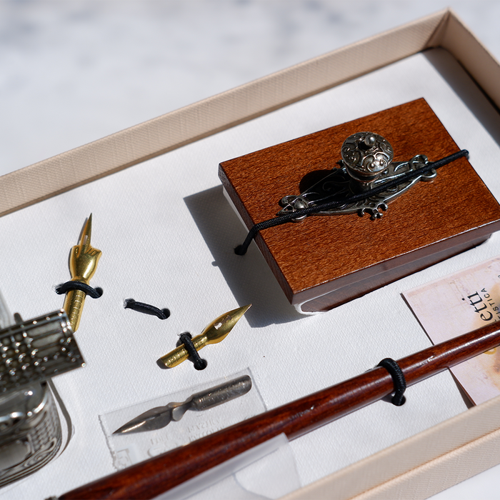 Bortoletti Calligraphy Set 61 featuring a calligraphy pen with black ink and decorative gold accents on a white background.