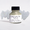 Bottled metallic silver calligraphy ink from Papier Plume, showcasing the shiny ink inside a clear glass bottle with a black cap.