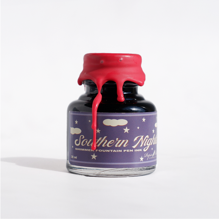 Papier Plume Southern Nights shimmer fountain pen ink bottle with dark, shimmering blue ink and elegant packaging.