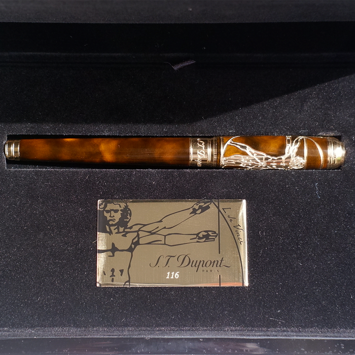S.T. Dupont Line D Vitruvian Man limited edition fountain pen with intricate design and gold accents, displayed on a white background.