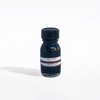 Papier Plume fountain pen ink in a Sapele wood-inspired bottle with rich amber-colored ink visible inside.