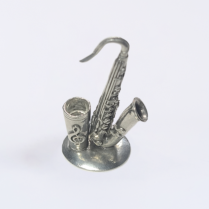 Le Potier D'Étain pewter saxophone-shaped pen rest stand for quill or pens, featuring detailed craftsmanship and a smooth finish.