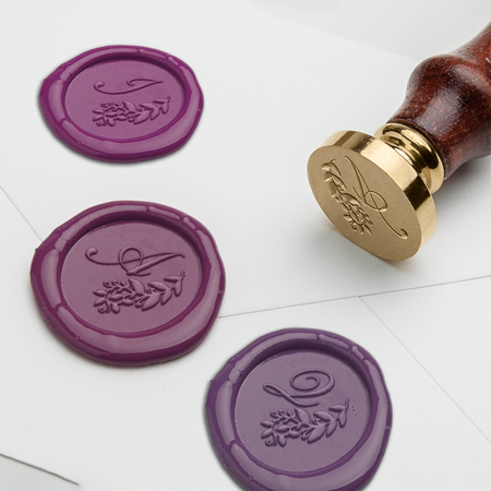 Papier Plume Script Monogram wax seal set with engraved script design on a round seal stamp.