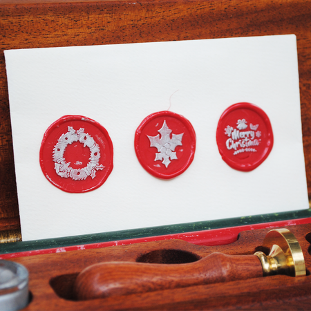 Papier Plume Christmas wax seal set with festive red and gold sealing wax and decorative seal stamps for holiday crafting.