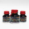 Papier Plume Singing Oak shimmer fountain pen ink bottle with dark ink and shimmering accents, ideal for writing and calligraphy.