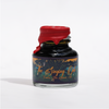 Papier Plume Singing Oak shimmer fountain pen ink in glass bottle with colorful ink swirls, showcasing the decorative ink design.
