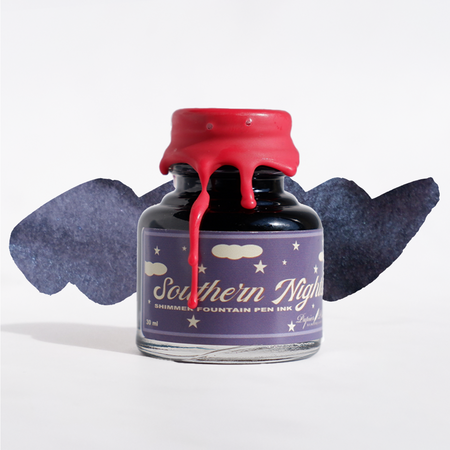 Swatch of Papier Plume Southern Nights shimmer fountain pen ink showing deep blue and purple hues with shimmering effects.