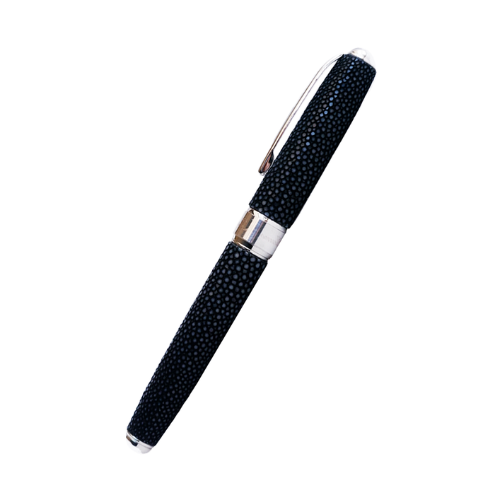 Grifos fountain pen with volcanic grey resin barrel and gold accents, featuring a sleek, ergonomic design for smooth writing.