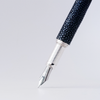 Grifos fountain pen with volcanic grey ink, featuring a sleek design and gold accents, perfect for writing elegance.