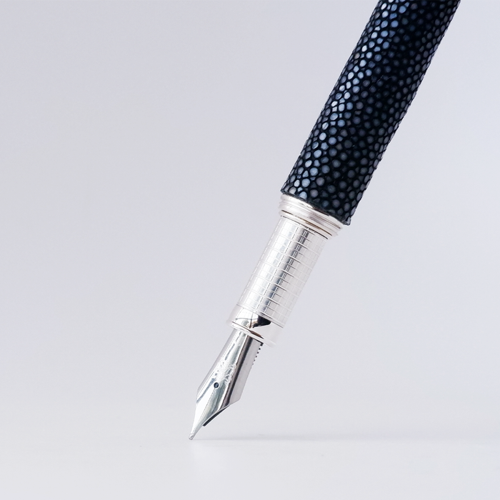 Grifos fountain pen with volcanic grey ink, featuring a sleek design and gold accents, perfect for writing elegance.