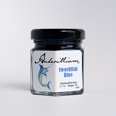 Anderillium Swordfish Blue fountain pen ink in a glass bottle with a label, vibrant blue color, suitable for writing and calligraphy