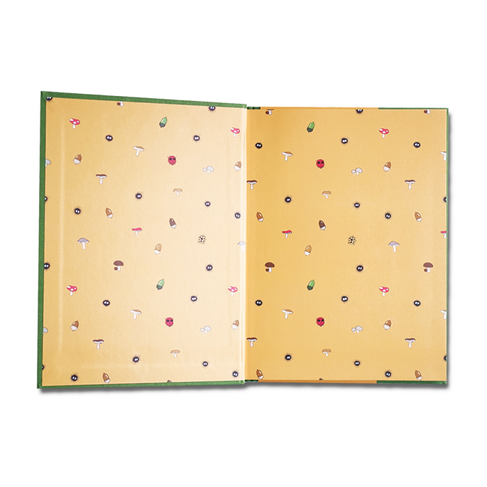 A Chronicle Books Studio Ghibli My Neighbor Totoro journal with a colorful cover featuring Totoro and forest imagery.