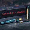 Esterbrook x BUNGUBOX Kingfisher Limited Edition Estie fountain pen with vibrant blue resin body and gold accents.