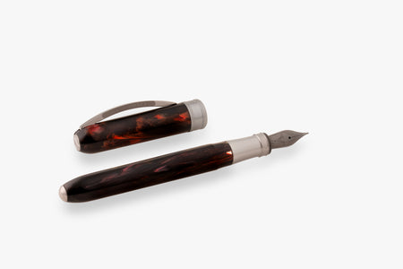Visconti Comedia Inferno fountain pen with black and gold accents, shown with a sleek ink cap and detailed barrel design.