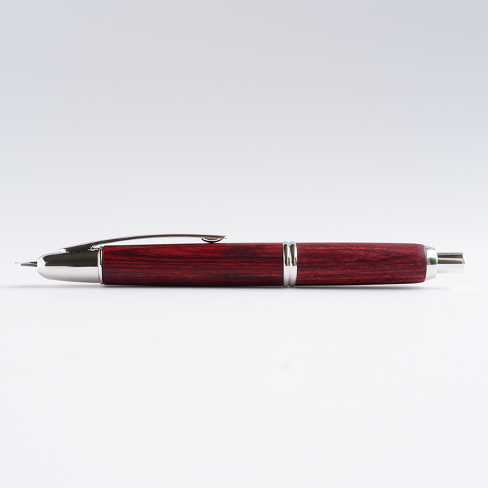 Pilot Vanishing Point fountain pen with a sleek birchwood barrel and gold accents, showcasing its elegant design and craftsmanship.