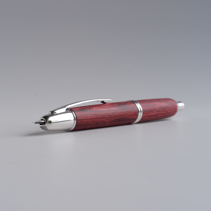 Pilot Vanishing Point fountain pen with a sleek birchwood barrel, showcasing its elegant design and fine writing tip.