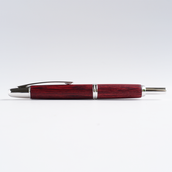Pilot Vanishing Point fountain pen with a sleek birchwood barrel and gold accents, featuring a retractable nib design.