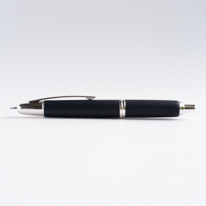 Pilot Vanishing Point fountain pen with black birchwood finish, sleek and stylish writing instrument with gold accents.