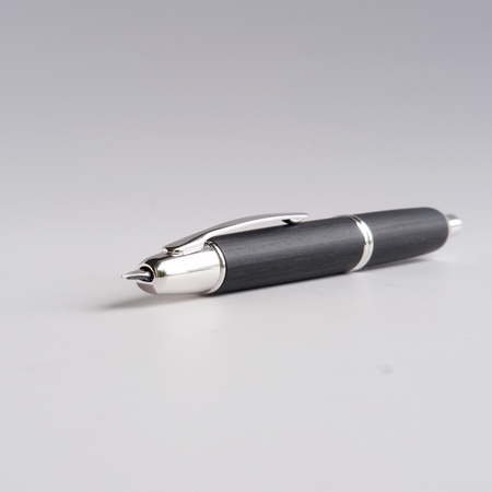 Pilot Vanishing Point fountain pen with black birchwood barrel and gold accents, showcasing its sleek and elegant design.