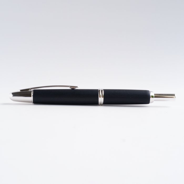 Pilot Vanishing Point fountain pen with black birchwood finish, showcasing the sleek design and gold accents of the writing instrument.