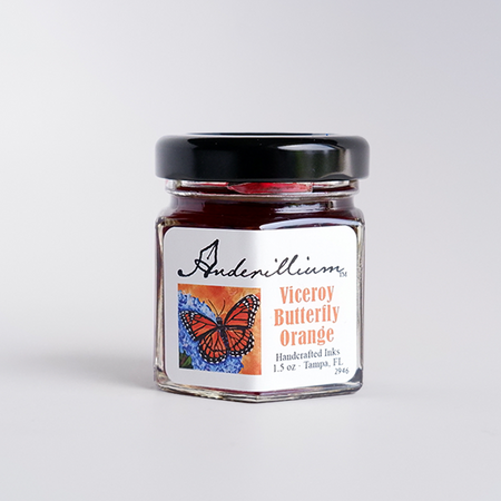 Bright orange fountain pen ink in a bottle from Anderillium's Viceroy Butterfly collection, with vibrant orange liquid visible.