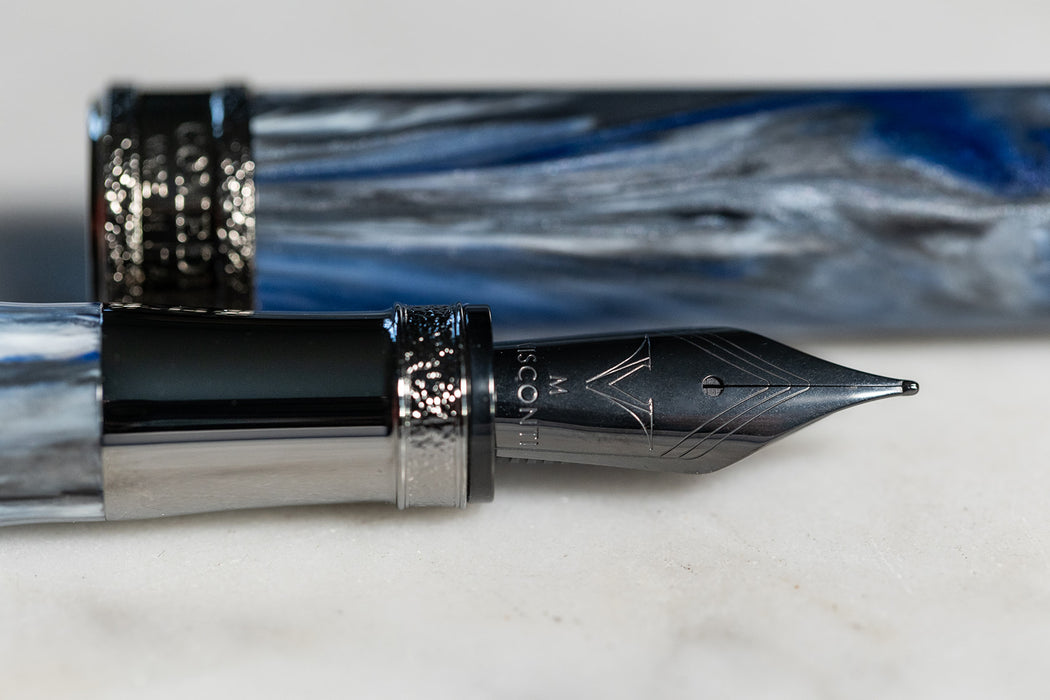 Visconti Comedia Caronte fountain pen with black resin body and gold accents, showcasing elegant design and craftsmanship.