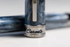 Visconti Comedia Caronte fountain pen with black resin body and gold accents, showcasing elegant design and craftsmanship.
