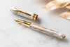 Visconti Comedia Virgilio fountain pen with polished resin body and gold accents, showcasing elegant craftsmanship.