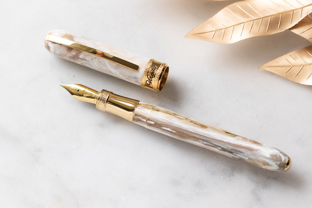 Visconti Comedia Virgilio fountain pen with polished resin body and gold accents, showcasing elegant craftsmanship.