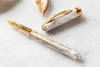 Visconti Comedia Virgilio fountain pen with elegant black and gold design, showcasing the detailed barrel and nib.