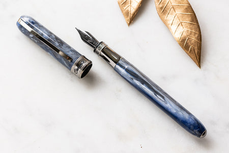 Visconti Comedia Caronte fountain pen with black resin body and gold accents, showcasing elegant craftsmanship and detailed design.