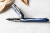 Visconti Comedia Caronte fountain pen with black and gold design, featuring a sleek, elegant appearance and intricate detailing.