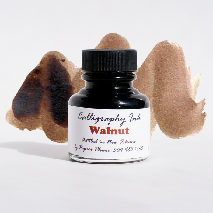 Bottled Papier Plume Walnut Calligraphy Ink with elegant glass container and ink swatch on white background