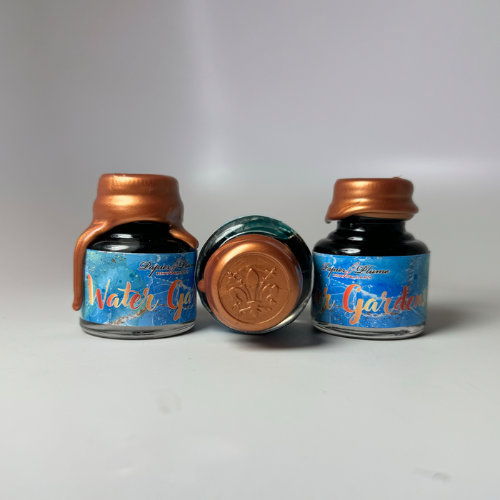 Papier Plume Dallas Pen Show Water Gardens fountain pen ink in limited edition bottle, vibrant blue ink for writing and calligraphy.
